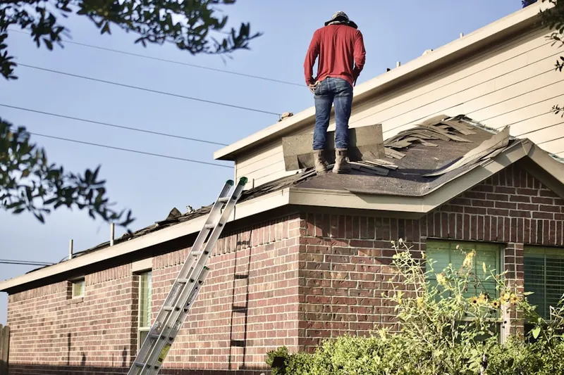 Professional roofer working on a residential roof in Hollsopple